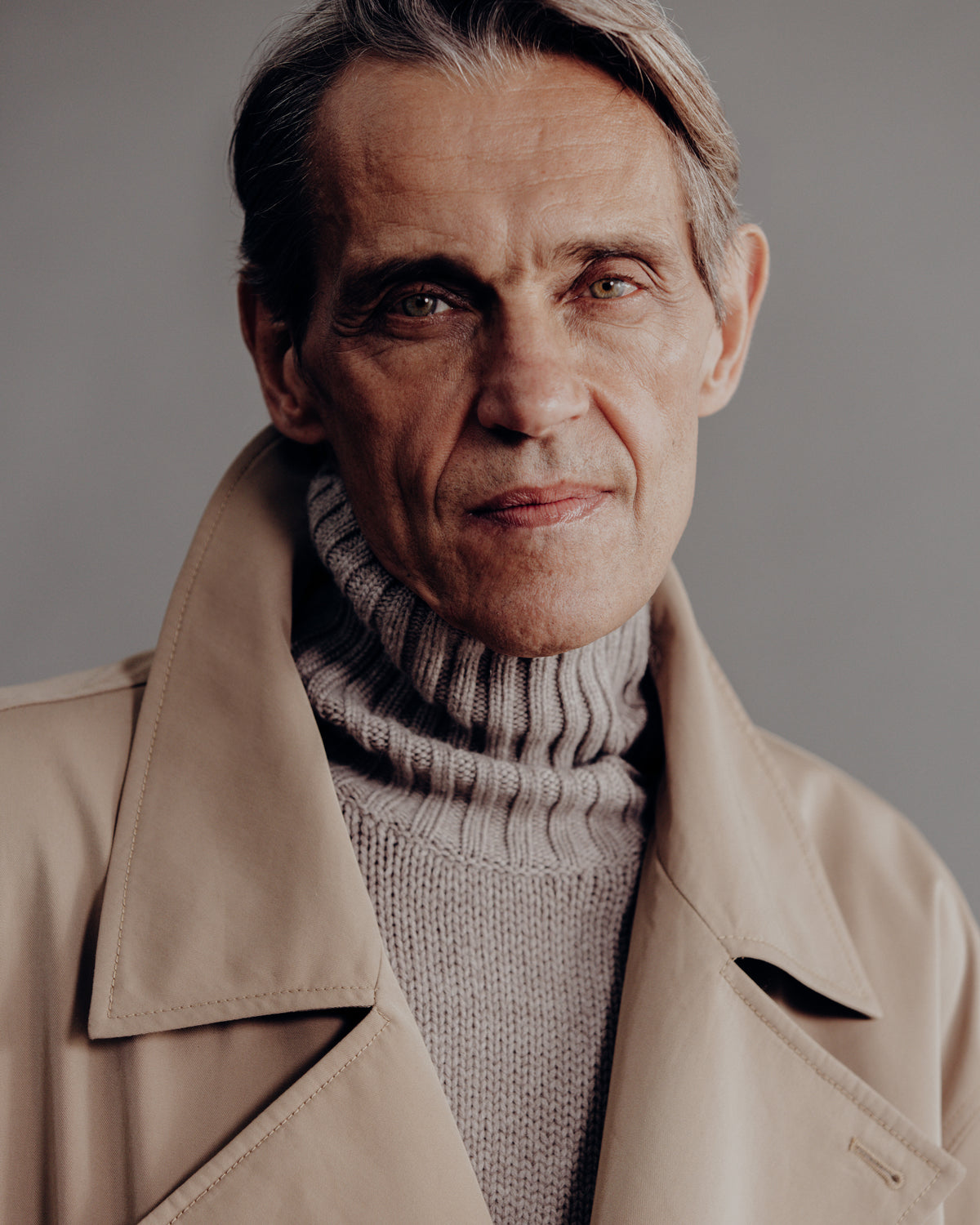 close-up of a man wearing the mink turtle neck sweater