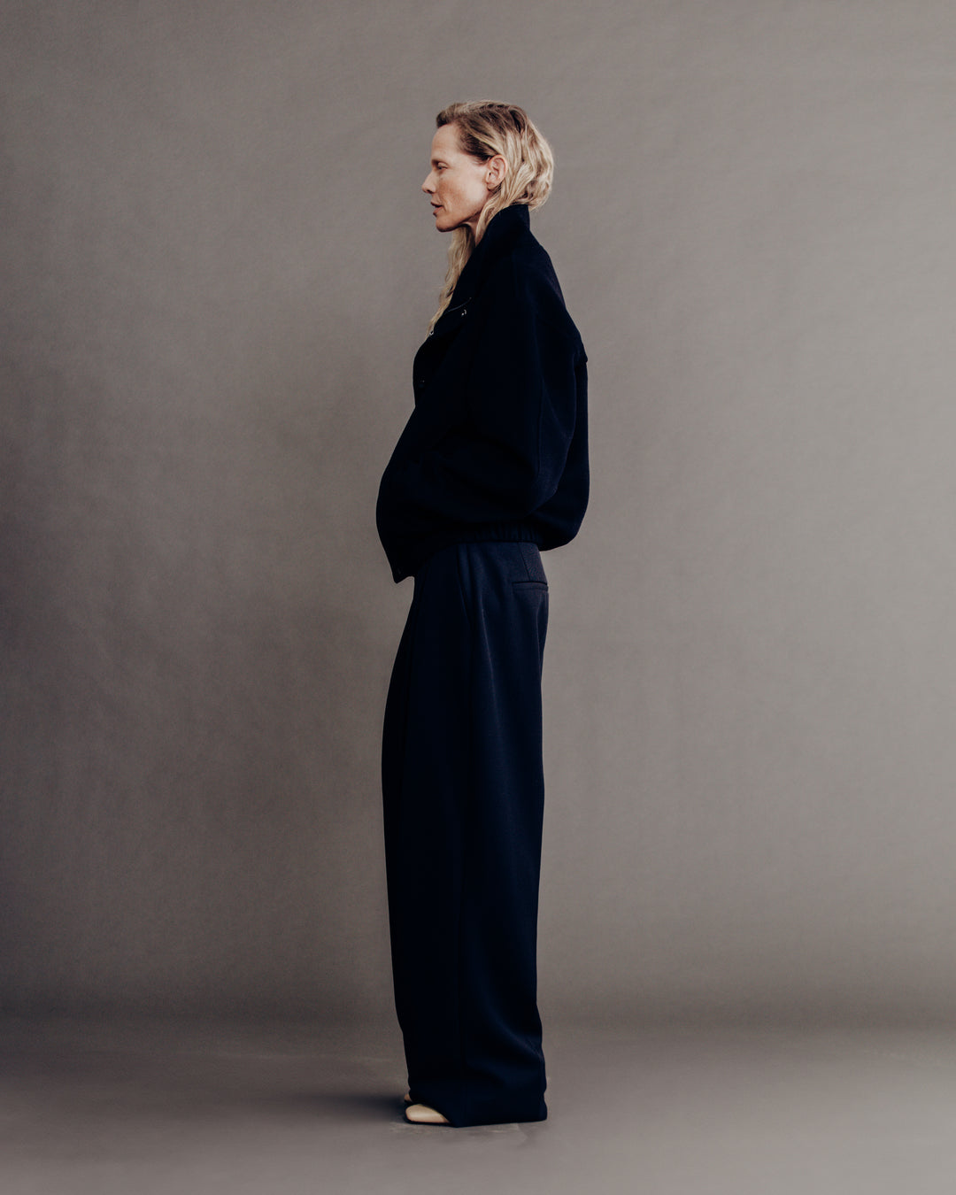 woman side profile full body, dark navy bomber