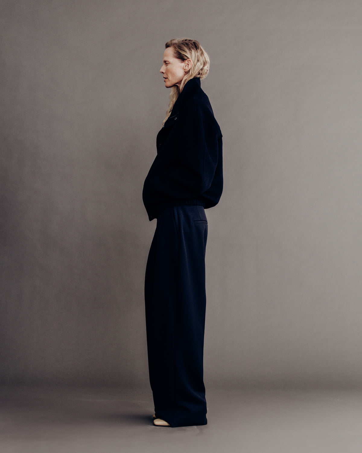 woman side profile full body, dark navy bomber